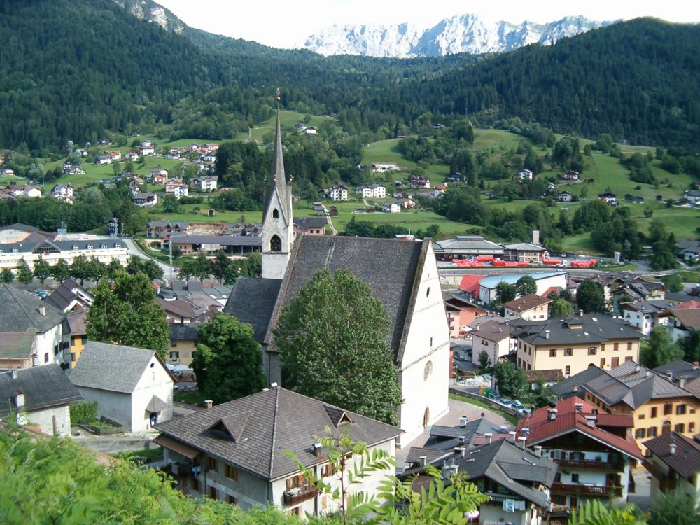 Village in the Primiero Valley, Trentino, with a church spire and the Dolomites rising behind